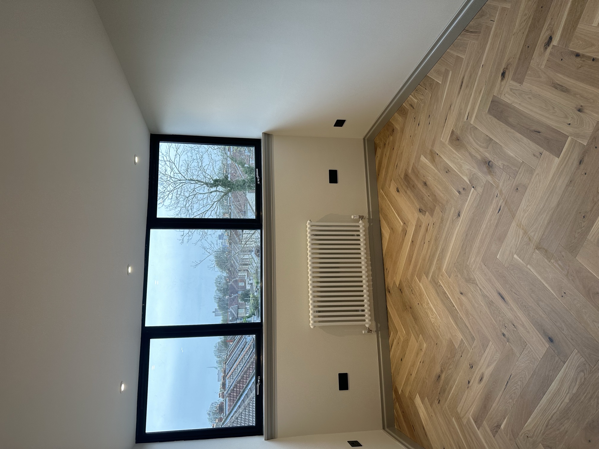 Portsmouth terrace house — bedroom with triple black-framed windows