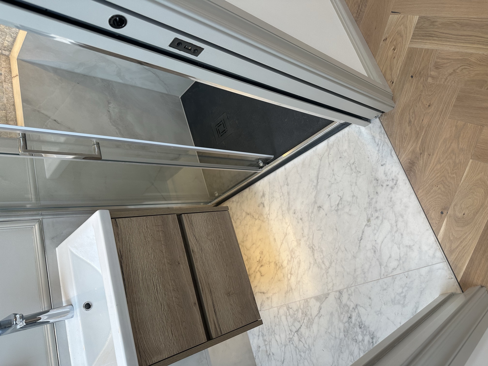 Portsmouth terrace house — en-suite vanity and shower with marble floor